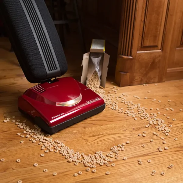 Vacuuming up cereal on a wood floor with the Riccar Supralite Premium Vacuum