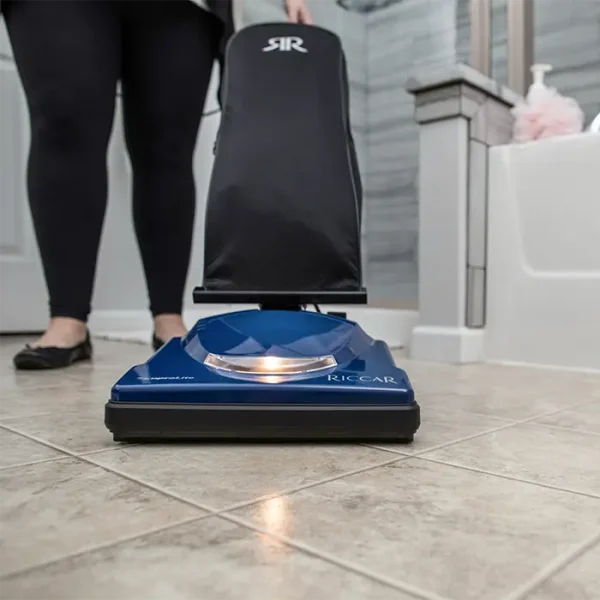 Vacuuming a bathroom floor with the Riccar Cordless SupraLite Vacuum