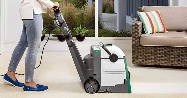 Woman pushing a Bissell Carpet Cleaning Vacuum