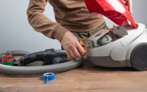 Person repairing vacuum cleaner